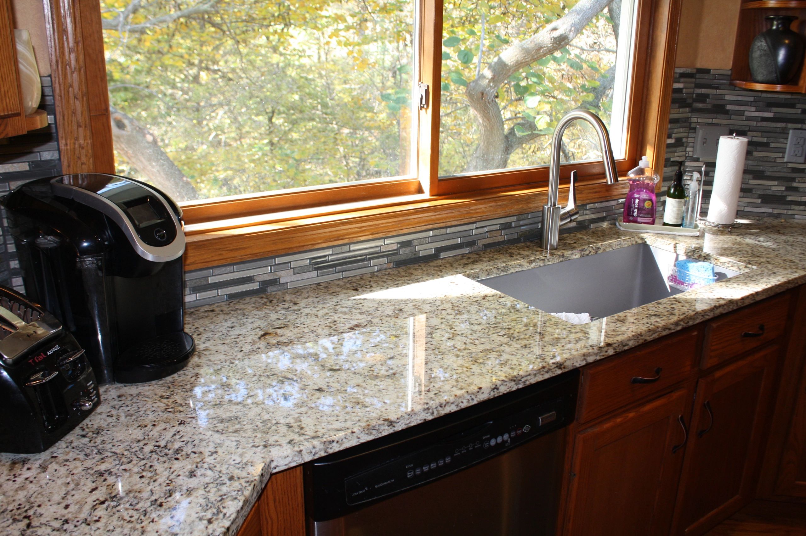 Granite kitchen sink with stainless steel faucet